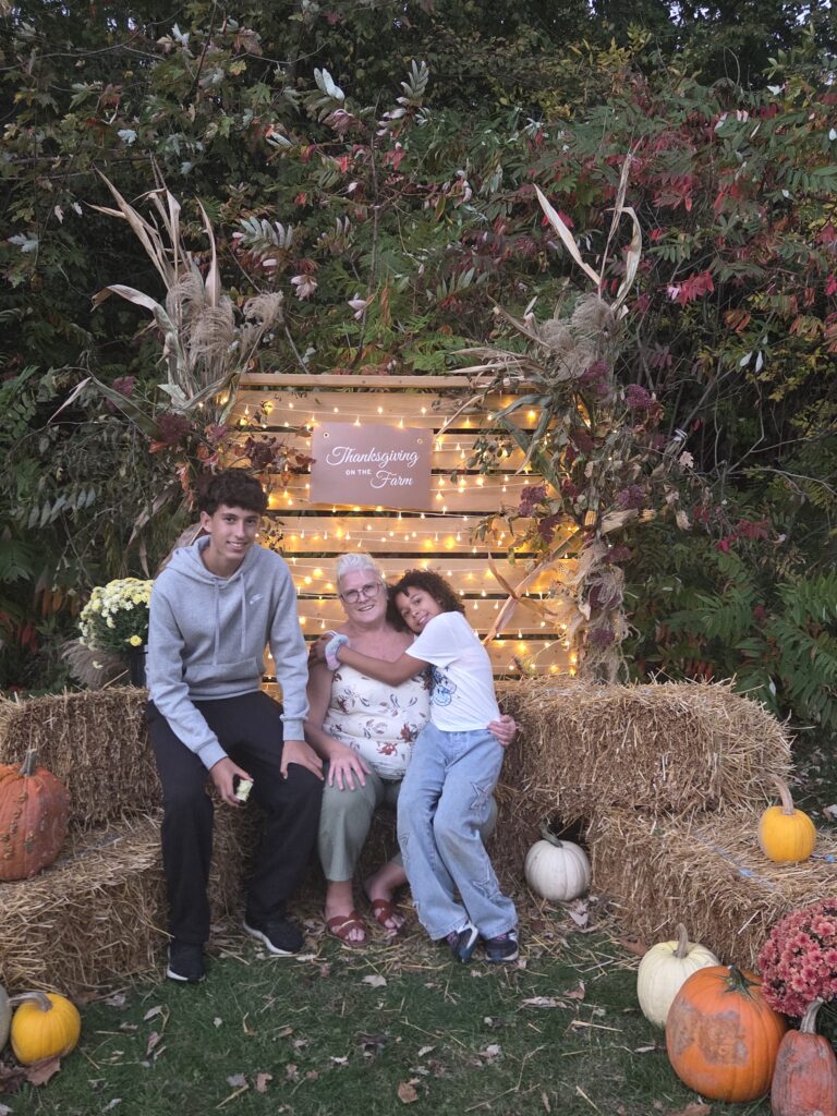 From left, Julio, Pattie Urry and Ellyiah pose together in an autumn display.